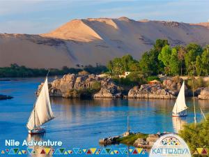 two boats on a river with mountains in the background at Kato Dool Wellness Resort in Aswan