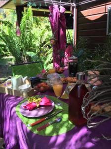 a table with a plate of food and a drink at Le Chalet dAZAE in La Rivière