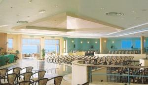 a large room with rows of chairs and tables at Hotel Club San Diego in Maratea