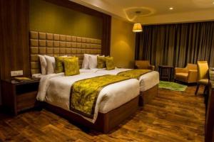 Llit o llits en una habitació de Lemon Tree Hotel Siliguri