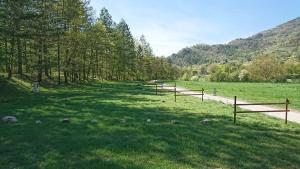 a field with wooden fences in the grass at Camping White Rock in Castellane