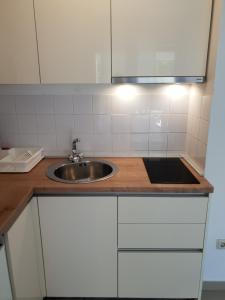 a kitchen with a sink and a counter top at Villa A in Pirovac +96 photos