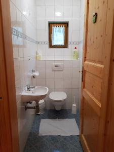a small bathroom with a toilet and a sink at Schweighofers Almhaus in Heilbrunn