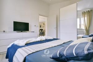 a bedroom with a large bed with a flat screen tv at Villa Emily in Peroj