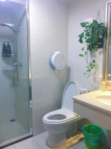 a bathroom with a shower and a toilet and a sink at YoYo Youth Apartment in Guangzhou