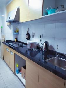 a kitchen with a sink and a counter top at YoYo Youth Apartment in Guangzhou