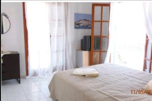 a bedroom with a bed with a towel on it at Sea view house on Poros in Poros