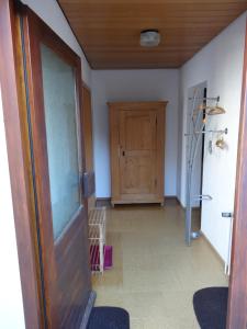 a hallway with a wooden door and a room at Lembergblick in Wellendingen
