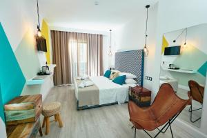 a hotel room with a bed and a chair at Blue Bottle Boutique Hotel in Thessaloniki