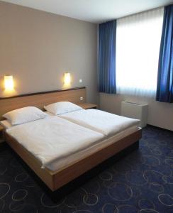 Postel nebo postele na pokoji v ubytování Hotel Bela Krajina