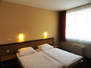 Postel nebo postele na pokoji v ubytování Hotel Bela Krajina