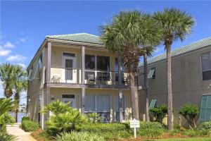 a large house with palm trees in front of it at Destiny Beach Villa #6A in Destin