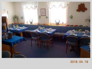 a dining room with blue tables and chairs at Porsche Hotel in Wolfsburg