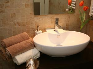 a bathroom with a white sink and a mirror at Alltominho – Villas Summer Holidays in Afife