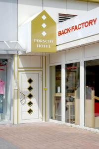 a store front with a sign that reads back factory at Porsche Hotel in Wolfsburg
