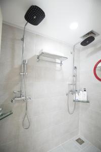 a bathroom with a shower with a shower head at Cheonjiyeon Crystal Hotel in Seogwipo +31 photos