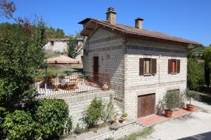 a small brick house with a patio in front of it at Casalilliput in Sassoferrato