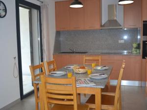 a kitchen with a table and chairs with food on it at Le Domaine De Marie in Palasca
