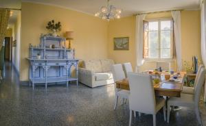 a living room with a table and a dining room at Casolare Al Dopolavoro in Lucca