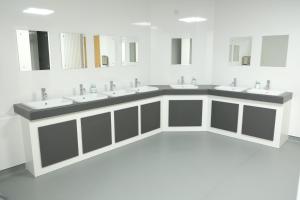 a bathroom with three sinks and a row of mirrors at Black Isle Hostel in Inverness