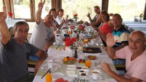 a group of people sitting around a table with food at NOSTALJİ CAVE SUİT HOTEL in Nevşehir
