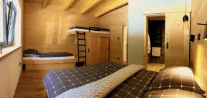 a small room with a bed and bunk beds at Chalet Slovensky Raj in Smižany