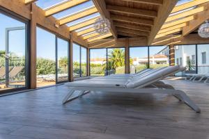 a large room with large windows and a bench at Thalacap Île de Ré - Thalasso & Spa in Ars-en-Ré