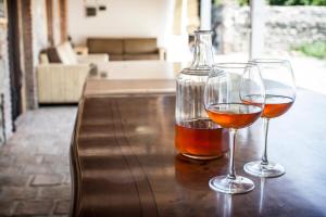 two glasses of wine sitting on a wooden table at Chateau Napareuli in Napareuli