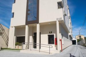 a white building with a sign on the side of it at Hotel Marrocos in Pelotas