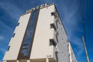 a building with a hotel sign on top of it at Hotel Marrocos in Pelotas