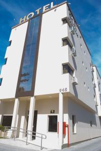a hotel building with a sign on it at Hotel Marrocos in Pelotas