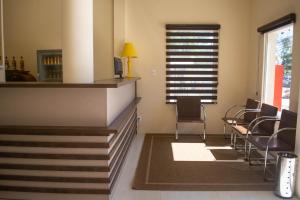 a waiting room with chairs and a window at Hotel Marrocos in Pelotas