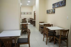 a row of tables and chairs in a restaurant at Hotel Marrocos in Pelotas