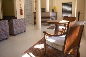 a dining room with a table and chairs at Hotel Marrocos in Pelotas