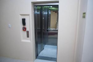 a glass door in a room with a hallway at Hotel Marrocos in Pelotas
