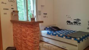 a bedroom with a bed and a brick fireplace at Apartment Marko in Zagreb
