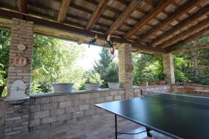 a ping pong table in an outdoor room with a ping pong table at Casalilliput in Sassoferrato