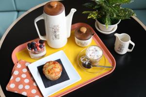 a tray with a plate of food on a table at The Dwell Hotel, a Member of Design Hotels in Chattanooga