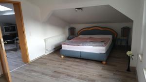 a bedroom with a bed with a wooden headboard at Ferienwohnung "Burgblick" in Heldrungen