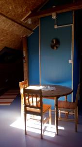 a table and two chairs in a room at Villa Moni in Lungsjön