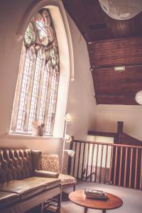 a room with a couch and a table and a window at Kirkby Stephen Hostel in Kirkby Stephen