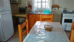 a kitchen with a table with a basket on it at El Encuentro in Juana Koslay 