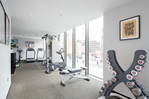 a gym with treadmills and exercise equipment in a building at Hotel Saint London in London +47 photos