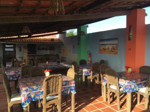 a dining room with tables and chairs in a restaurant at POUSADA MARINA PRAiA in Beberibe