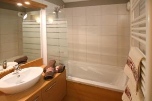 a bathroom with a sink and a bath tub at Time to Ski - Porthos in Sainte-Foy-Tarentaise +3 photos