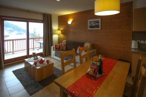 a living room with a couch and a table in a room at Time to Ski - Porthos in Sainte-Foy-Tarentaise