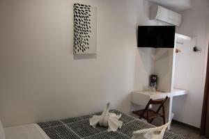 a bedroom with a bed and a table and a desk at Hostal Abril Madrid in Madrid