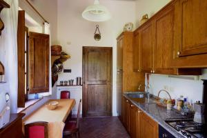 a kitchen with wooden cabinets and a counter top at Casale Lombriciano in Cortona