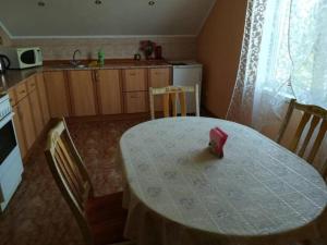 a kitchen with a table and chairs and a table and a table and a kitchen at Готель Алекс in Lutsk +11 photos