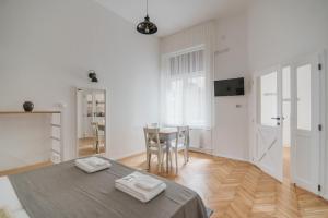 a white room with a table and a dining room at Lizmary's Wonderland in Budapest